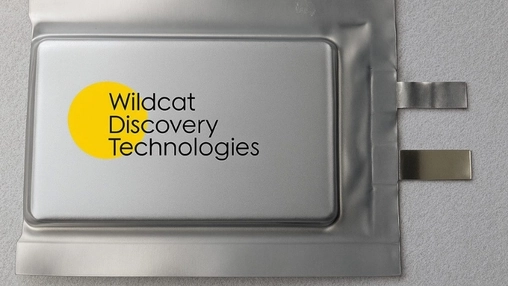 Silver pouch cell battery sample branded with the Wildcat Discovery Technologies logo on a grey surface
